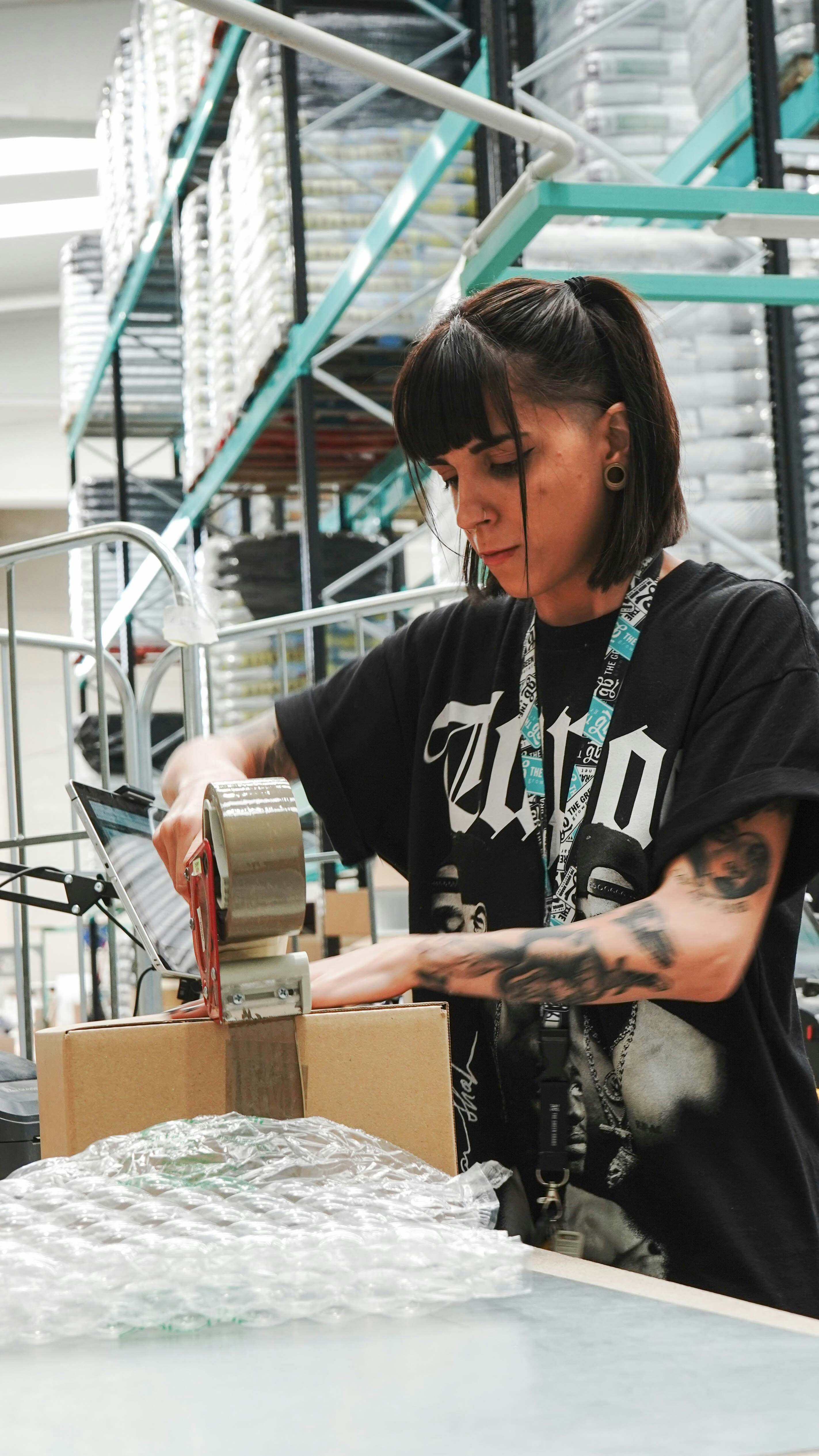 A packer sealing an order at a pack station